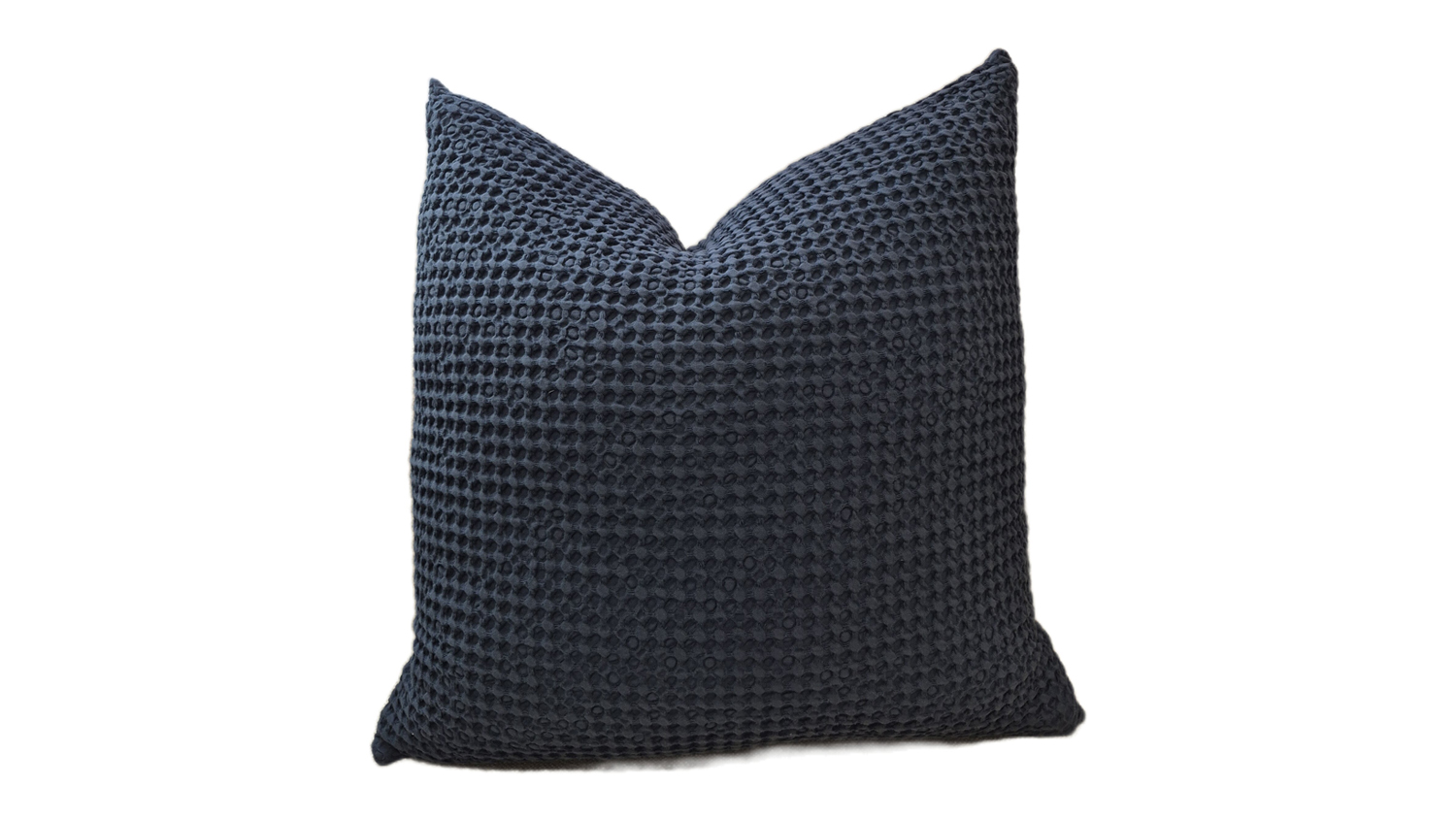 Soft navy-coloured cushion with a feather-filled interior, featuring a textured surface and waffle-like pattern